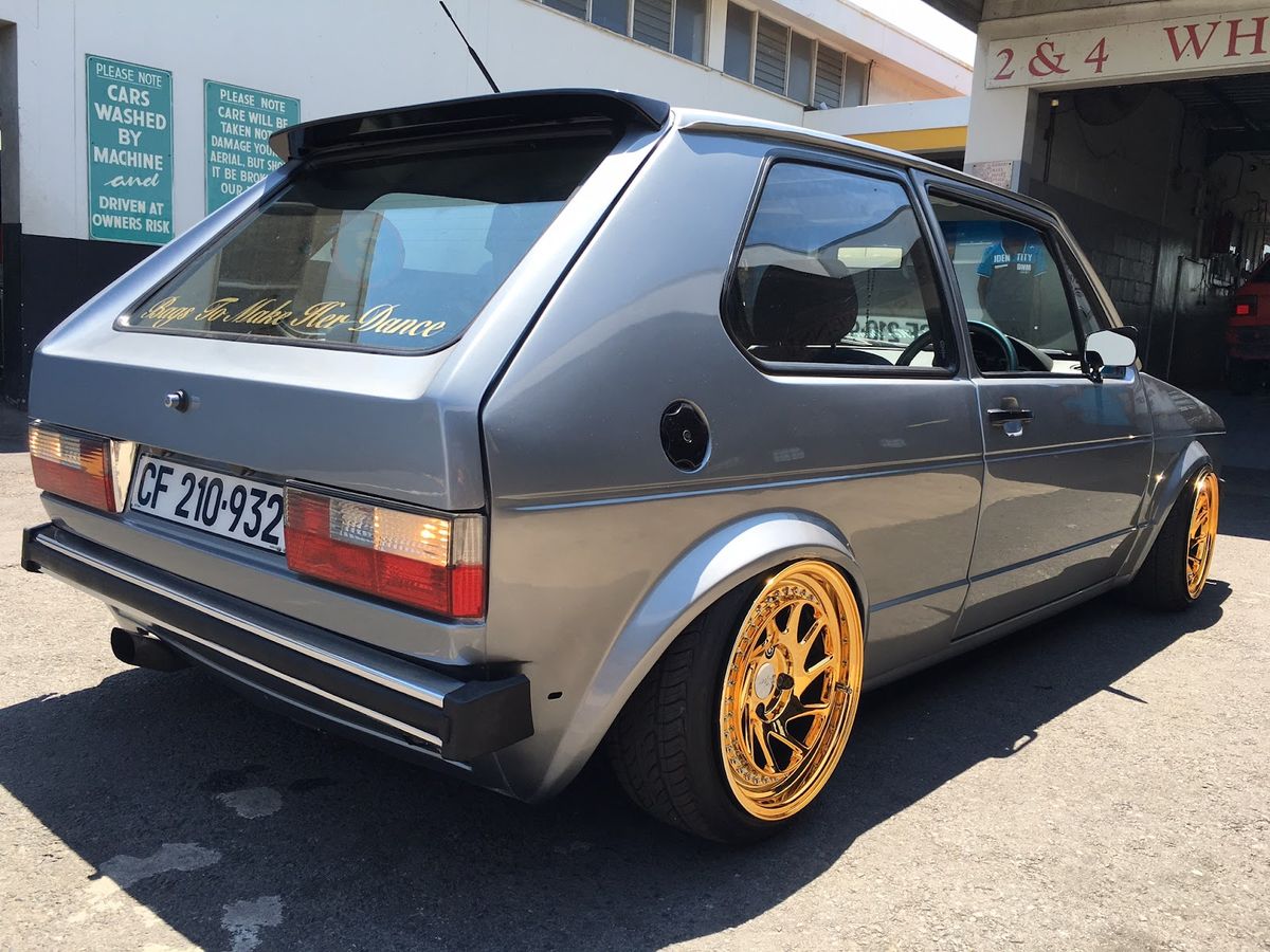 Lowered VW Golf with gold wheels