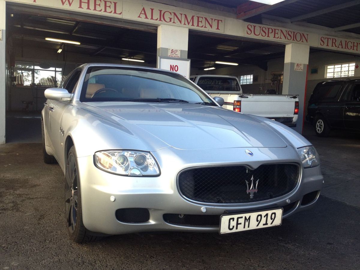 Maserati Quattroporte in front of the alignment bays